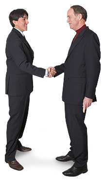 two men in black suits shaking hands